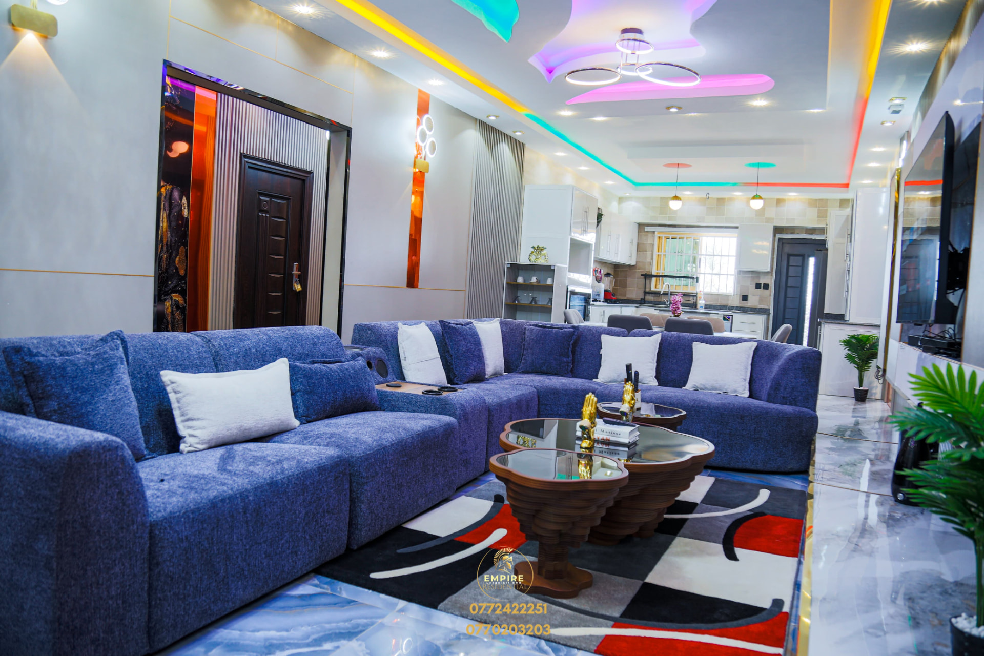 Blue furnished lounge with open kitchen at Empire Lodge